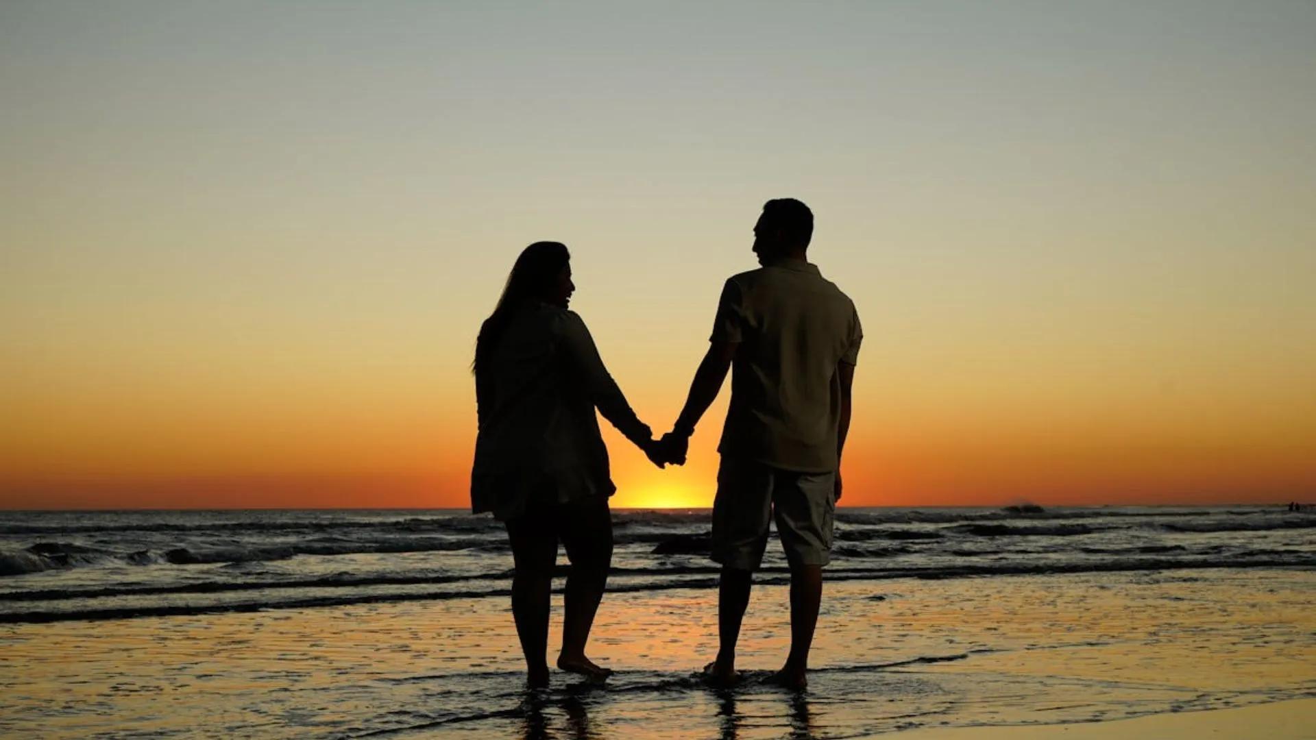 Couple on a beach holding hands