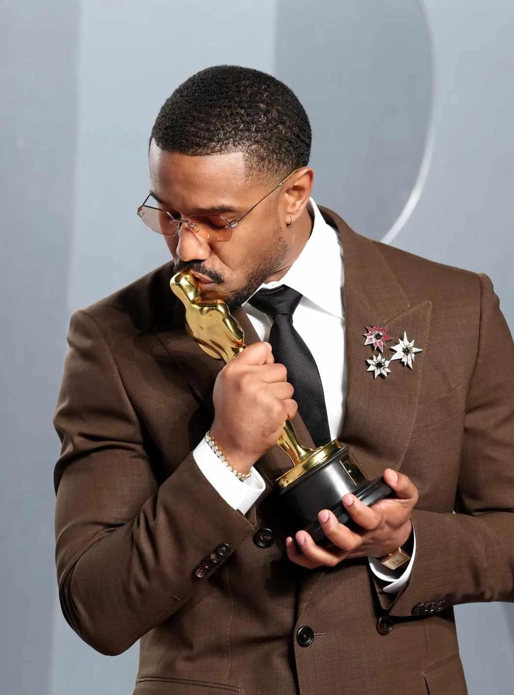 Michael B. Jordan wearing a cluster of brooches at the Vanity Fair Oscars 2026 party