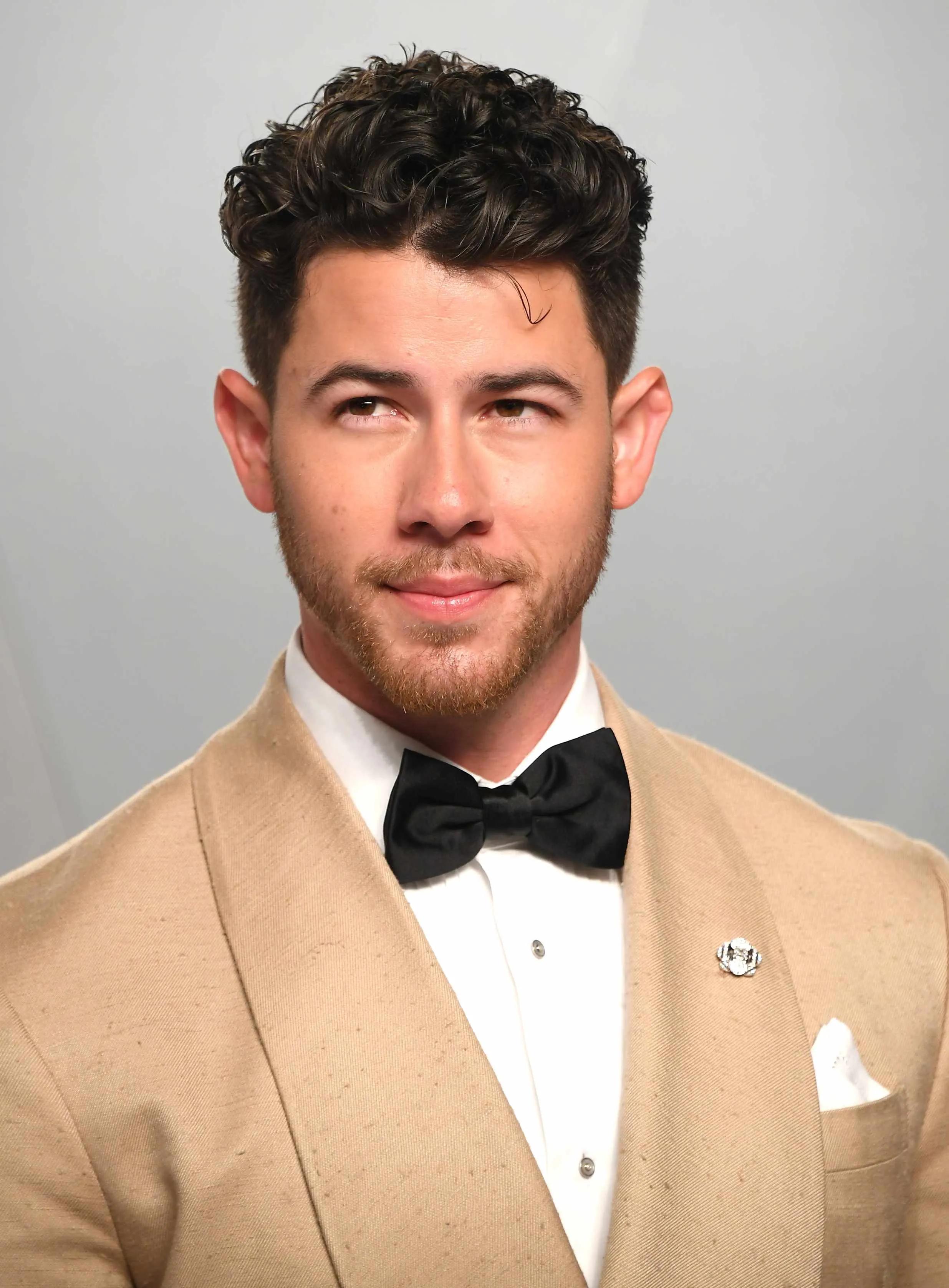 Nick Jonas wearing a tiny brooch at the Vanity Fair Oscars 2026 party