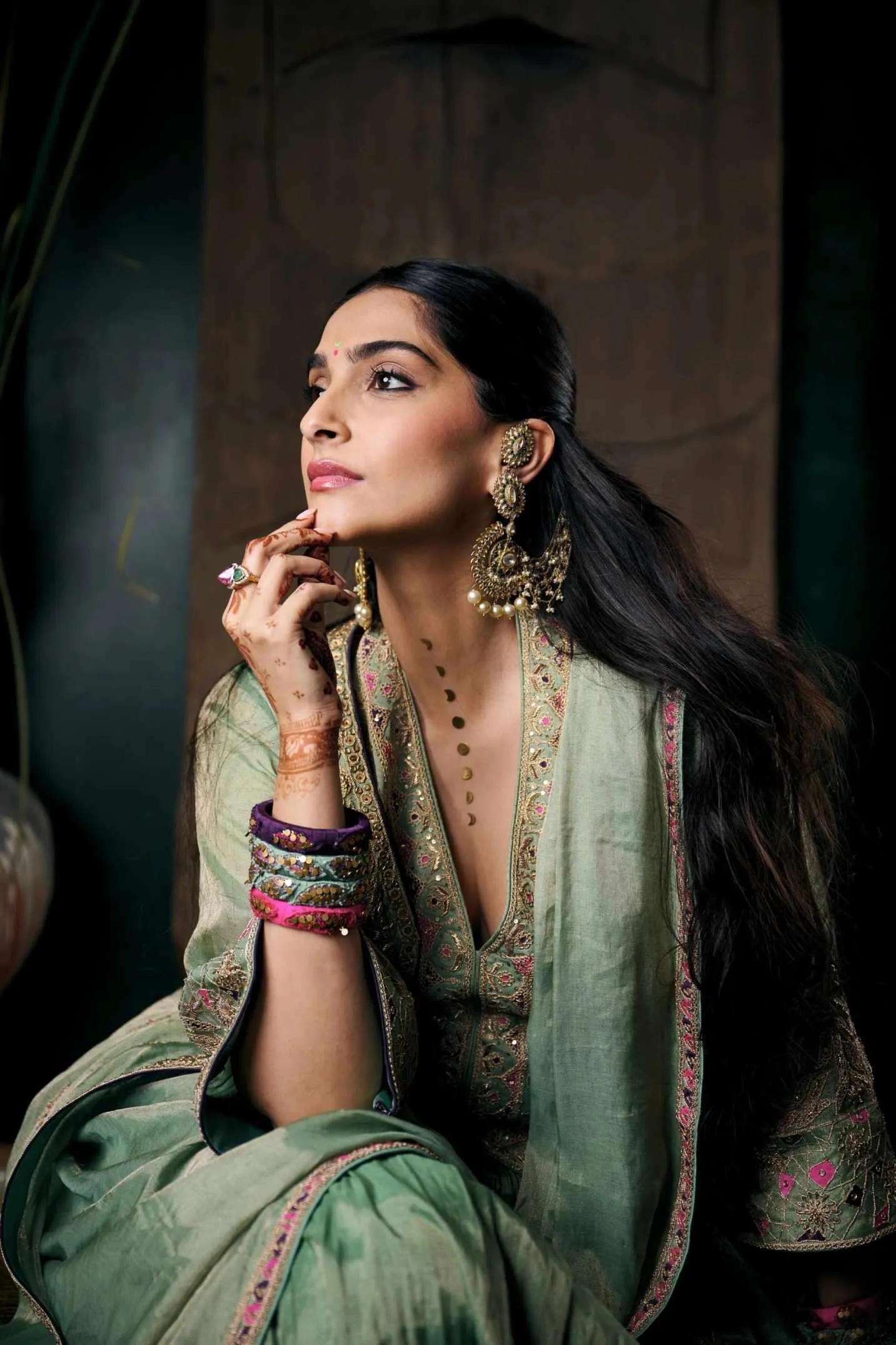 Sonam Kapoor wearing tiny stickers of the the different phases of moon on her neck