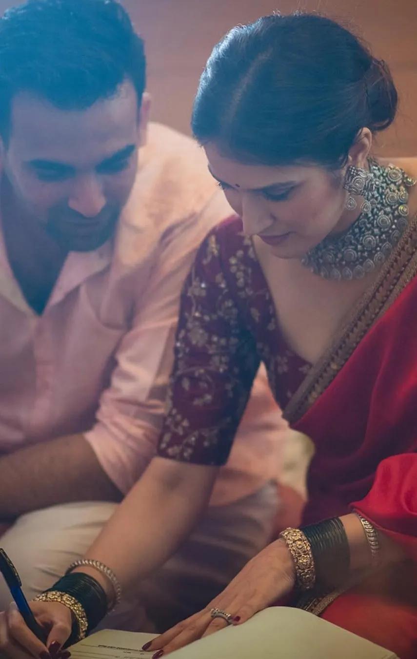 Sagarika Ghatge wore a plain red sari with embellished blouse and border for her court wedding with Zaheer Khan